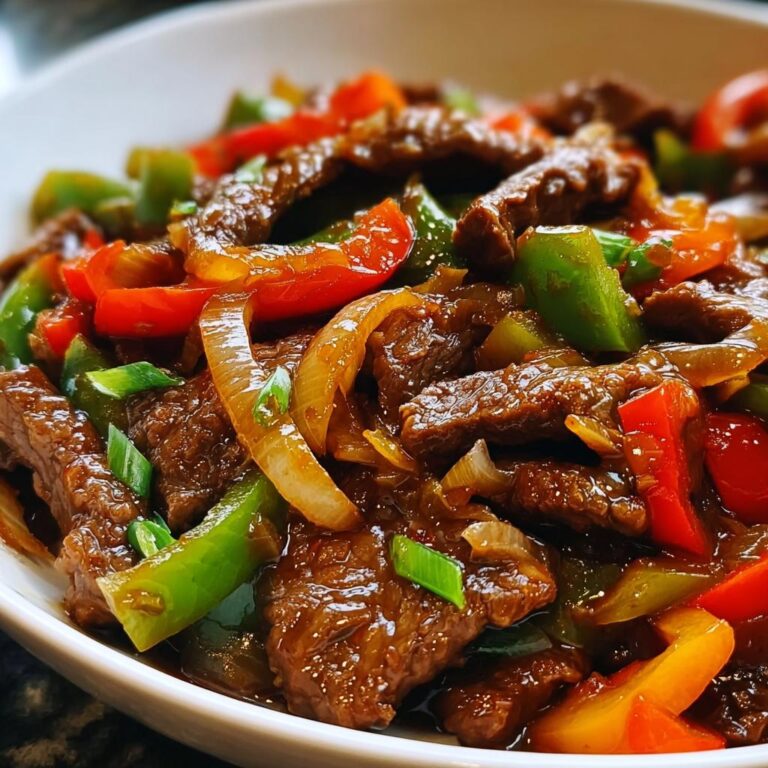 Nahaufnahme vom fertigen Stir-Fry mit Rindfleisch & Paprika in einer weißen Schüssel.